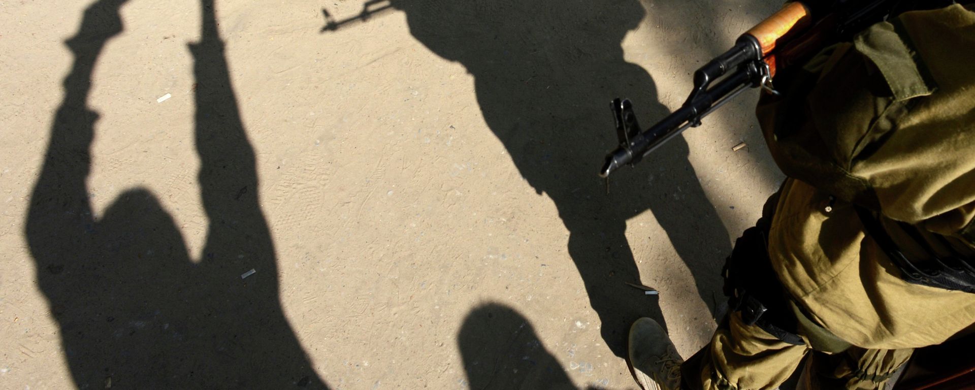 A photographer takes a picture of an armed man in military fatigues standing guard outside the security service (SBU) regional building in the eastern Ukrainian city of Slavyansk on April 23, 2014 - Sputnik International, 1920, 23.04.2022