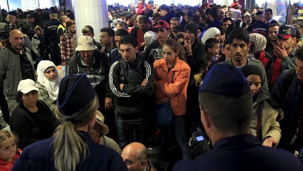 Migrants, who mostly crossed into the country from Serbia and are hoping to make their way to Austria, wait for trains heading to Hegyeshalom or Gyor, in a transit area at Keleti station in Budapest, Hungary, September 12, 2015 - Sputnik International