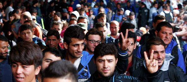 Migrants walk on the platform after arriving by train at the main railway station in Munich, Germany September 13, 2015 Migrants walk on the platform after arriving by train at the main railway station in Munich, Germany September 13, 2015 - Sputnik International