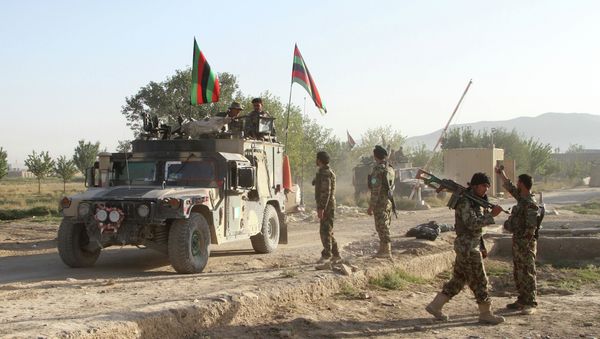 Afghan national army stand guard near the dead body of a Taliban attacker in front of the main prison building after an attack in Ghazni province, eastern Afghanistan, Monday, Sept. 14, 2015 Afghan national army stand guard near the dead body of a Taliban attacker in front of the main prison building after an attack in Ghazni province, eastern Afghanistan, Monday, Sept. 14, 2015 - Sputnik International