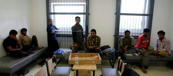 A group of refugees from Pakistan and India caught illegally crossing the Slovakian border wait at a detention center in the east Slovakian village of Podhorod, in this June 12, 2007 file photo - Sputnik International