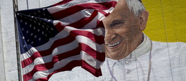 The US flag flies in front of a mural of Pope Francis on the side of a building in midtown Manhattan in New York August 28, 2015 The US flag flies in front of a mural of Pope Francis on the side of a building in midtown Manhattan in New York August 28, 2015 - Sputnik International