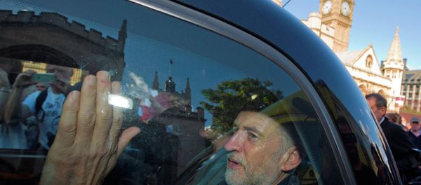 Newly elected leader of Britain's opposition Labour party, Jeremy Corbyn, passes the Houses of Parliament and Big Ben as he leaves in the back of a taxi after addressing a pro-refugee rally in central London on September 12, 2015. - Sputnik International