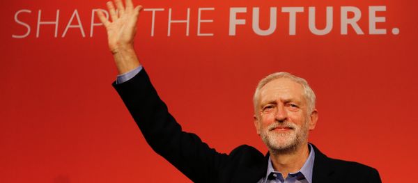 Jeremy Corbyn waves on stage after new is announced as the new leader of The Labour Party during the Labour Party Leadership Conference in London. - Sputnik International