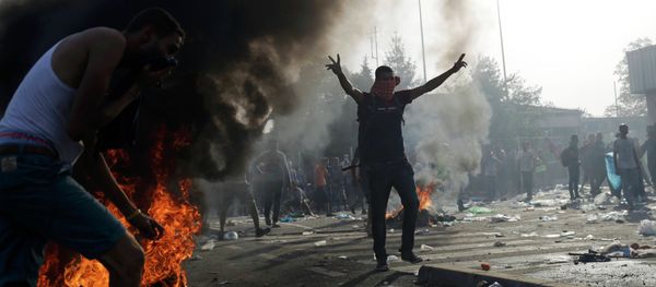 A migrant taunts Hungarian riot police as they fire tear gas and water cannon on the Serbian side of the border, near Roszke, Hungary September 16, 2015 A migrant taunts Hungarian riot police as they fire tear gas and water cannon on the Serbian side of the border, near Roszke, Hungary September 16, 2015 - Sputnik International