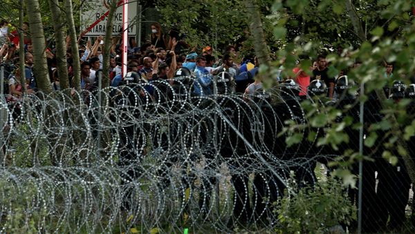Hungarian riot police secure the border as migrants attempt to break out from the no-man's land between the two countries at the Hungarian-Serbian border of Roszke station Hungarian riot police secure the border as migrants attempt to break out from the no-man's land between the two countries at the Hungarian-Serbian border of Roszke station - Sputnik International