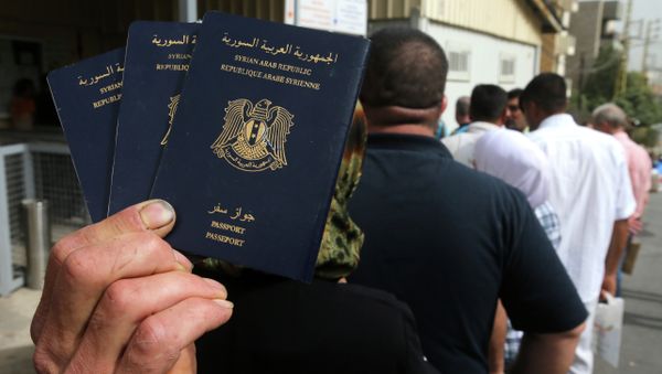 Syrian man holds his family's passports Syrian man holds his family's passports - Sputnik International