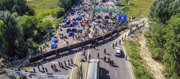 An aerial view taken on September 16, 2015 shows migrants camping on no-man's land of the border between Hungary and Serbia near Roeszke An aerial view taken on September 16, 2015 shows migrants camping on no-man's land of the border between Hungary and Serbia near Roeszke - Sputnik International
