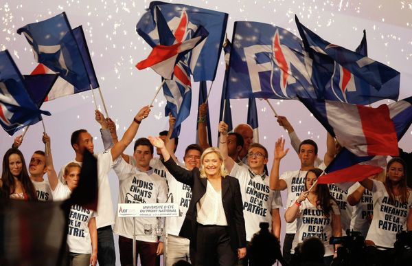 France’s far-right National Front president Marine Le Pen, center, surrounded by members, waves to supporters after her speech during their meeting in Marseille, southern France, Saturday, Sep. 6, 2015. - Sputnik International