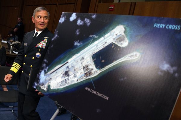 Adm. Harry B. Harris, Jr., US Navy Commander, U.S. Pacific Command walks past a photograph showing an island that China is building on the Fiery Cross Reef in the South China Sea Adm. Harry B. Harris, Jr., US Navy Commander, U.S. Pacific Command walks past a photograph showing an island that China is building on the Fiery Cross Reef in the South China Sea - Sputnik International