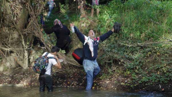A migrant reacts after crossing the river Sutla near Senkovec, Croatia on their way to Slovenia September 18, 2015. - Sputnik International