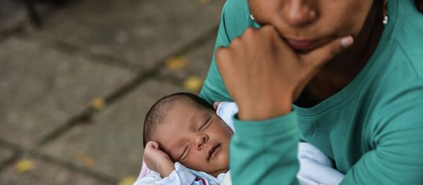 Seven-day-old Ali Taher, who was born on the Greek island of Lesbos, sleeps while his mother and other migrants take a break as they head towards the Serbia-Croatia border near the town of Bezdan on September 17, 2015. Seven-day-old Ali Taher, who was born on the Greek island of Lesbos, sleeps while his mother and other migrants take a break as they head towards the Serbia-Croatia border near the town of Bezdan on September 17, 2015. - Sputnik International