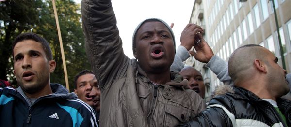 Refugees and their supporters demonstrate outside of a meeting of EU justice and interior ministers at the EU Council building in Brussels on Monday, Sept. 14, 2015 Refugees and their supporters demonstrate outside of a meeting of EU justice and interior ministers at the EU Council building in Brussels on Monday, Sept. 14, 2015 - Sputnik International