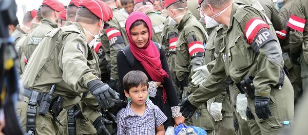 A migrant family is directed by Austrian soldiers at the Hungarian-Austrian border in Szentgotthard, Hungary, as thousands of migrants wait for their departure to Germany on September 19, 2015 A migrant family is directed by Austrian soldiers at the Hungarian-Austrian border in Szentgotthard, Hungary, as thousands of migrants wait for their departure to Germany on September 19, 2015 - Sputnik International