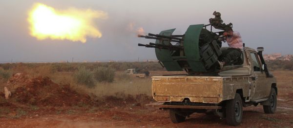 Rebel fighters fire a heavy machine gun during clashes with Syrian pro-government forces on the frontline facing Deir al-Zoghb, a government-held area in the northwestern Idlib province, on August 31, 2015 - Sputnik International