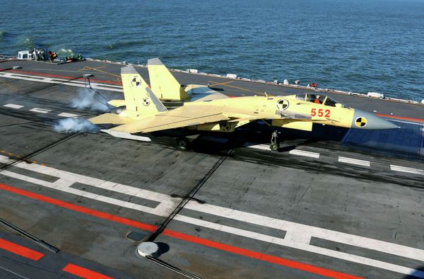 In this undated photo released by China's Xinhua News Agency, a carrier-borne J-15 fighter jet lands on China's first aircraft carrier, the Liaoning - Sputnik International