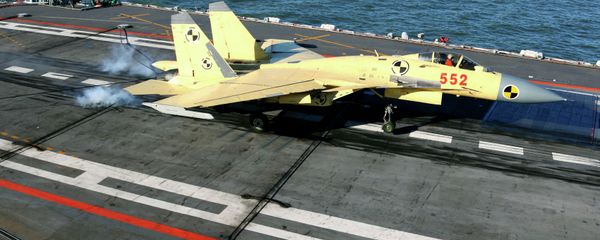 In this undated photo released by China's Xinhua News Agency, a carrier-borne J-15 fighter jet lands on China's first aircraft carrier, the Liaoning - Sputnik International