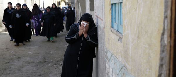 A woman mourns for the Egyptian Coptic Christians captured in Libya and killed by militants affiliated with the Islamic State group, outside of the Virgin Mary church in the village of el-Aour, near Minya, 220 kilometers (135 miles) south of Cairo, Egypt, Monday, Feb. 16, 2015 A woman mourns for the Egyptian Coptic Christians captured in Libya and killed by militants affiliated with the Islamic State group, outside of the Virgin Mary church in the village of el-Aour, near Minya, 220 kilometers (135 miles) south of Cairo, Egypt, Monday, Feb. 16, 2015 - Sputnik International