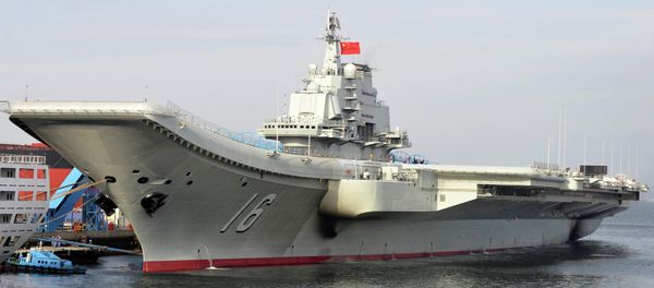 In this photo released by the Xinhua News Agency, Chinese aircraft carrier Liaoning berths in a port. China formally introduced its first aircraft carrier into service on Tuesday, Sept. 25, 2012 In this photo released by the Xinhua News Agency, Chinese aircraft carrier Liaoning berths in a port. China formally introduced its first aircraft carrier into service on Tuesday, Sept. 25, 2012 - Sputnik International