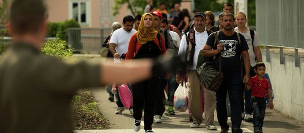 Migrants crossing the border between Austria and Slovenia in Bad Radkersburg, about 210 kms (130 miles) south of Vienna, Austria, Sunday, Sept. 20, 2015. Migrants crossing the border between Austria and Slovenia in Bad Radkersburg, about 210 kms (130 miles) south of Vienna, Austria, Sunday, Sept. 20, 2015. - Sputnik International
