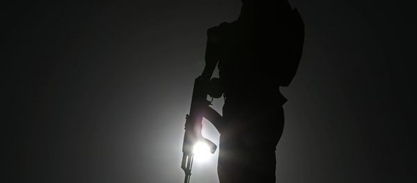 An Afghan police officer stands guard during a campaign rally in the Paghman district of Kabul, Afghanistan, Monday, June 9, 2014. - Sputnik International