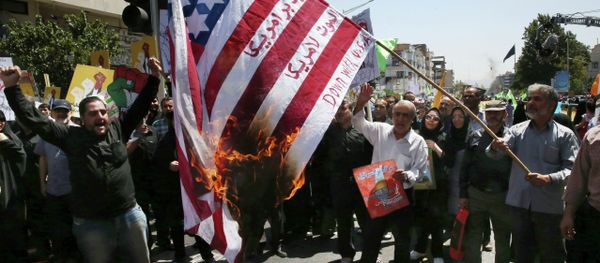 Iranian demonstrators burn a representation of the U.S. flag reading down with America, in Arabic and Persian, during an annual pro-Palestinian rally marking Al-Quds (Jerusalem) Day at the Enqelab-e-Eslami (Islamic Revolution) St. in Tehran, Iran, Friday, July 10, 2015 Iranian demonstrators burn a representation of the U.S. flag reading down with America, in Arabic and Persian, during an annual pro-Palestinian rally marking Al-Quds (Jerusalem) Day at the Enqelab-e-Eslami (Islamic Revolution) St. in Tehran, Iran, Friday, July 10, 2015 - Sputnik International