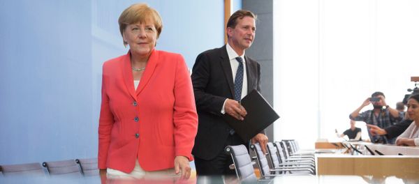 German Chancellor Angela Merkel, left, and government spokesman Steffen Seibert leave after Merkel's annual summer news conference in Berlin, Germany, Monday, Aug. 31, 2015 German Chancellor Angela Merkel, left, and government spokesman Steffen Seibert leave after Merkel's annual summer news conference in Berlin, Germany, Monday, Aug. 31, 2015 - Sputnik International