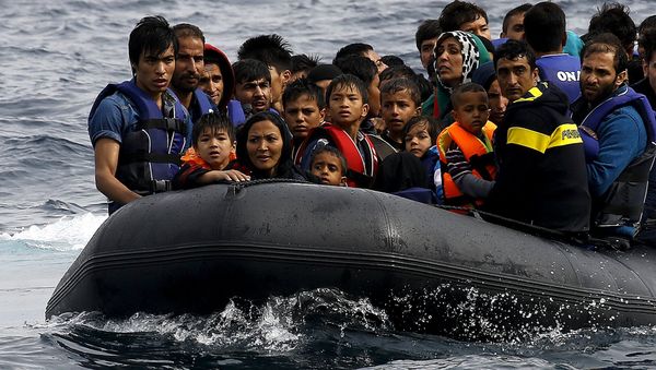 Exhausted Afghan migrants arrive on the Greek island of Lesbos in an overcrowded dinghy after crossing a part of the Aegean Sea from the Turkish coast September 22, 2015 Exhausted Afghan migrants arrive on the Greek island of Lesbos in an overcrowded dinghy after crossing a part of the Aegean Sea from the Turkish coast September 22, 2015 - Sputnik International
