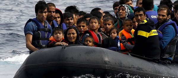 Exhausted Afghan migrants arrive on the Greek island of Lesbos in an overcrowded dinghy after crossing a part of the Aegean Sea from the Turkish coast September 22, 2015 Exhausted Afghan migrants arrive on the Greek island of Lesbos in an overcrowded dinghy after crossing a part of the Aegean Sea from the Turkish coast September 22, 2015 - Sputnik International