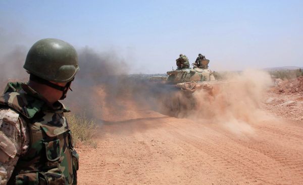 Syrian government forces drive a tank on a road in the Maysar neighbourhood of the northern Syrian city of Aleppo on July 29, 2015 Syrian government forces drive a tank on a road in the Maysar neighbourhood of the northern Syrian city of Aleppo on July 29, 2015 - Sputnik International