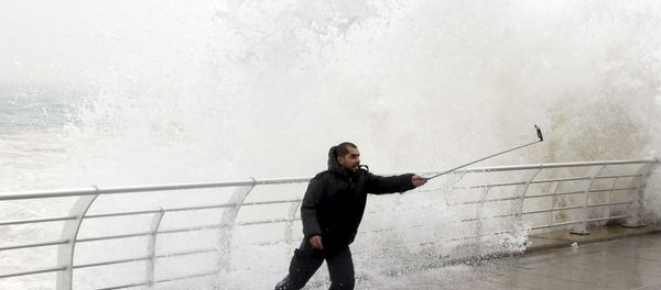 A man takes a selfie by a crashing wave on Beirut's Corniche, a seaside promenade, as high winds sweep through Lebanon during a storm in this February 11, 2015 file photo. A man takes a selfie by a crashing wave on Beirut's Corniche, a seaside promenade, as high winds sweep through Lebanon during a storm in this February 11, 2015 file photo. - Sputnik International