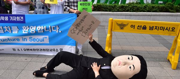 A South Korean activist wearing a mask depicting North Korean leader Kim Jong-Un lies on a street during a rally to welcome the opening of the UN Human Rights office at Seoul Global Center in Seoul on June 23, 2015 A South Korean activist wearing a mask depicting North Korean leader Kim Jong-Un lies on a street during a rally to welcome the opening of the UN Human Rights office at Seoul Global Center in Seoul on June 23, 2015 - Sputnik International