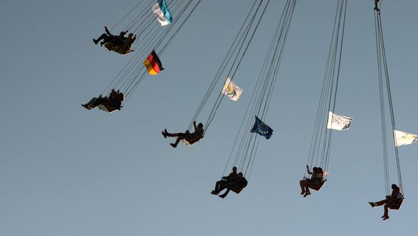 A picture taken on September 21, 2015 shows people enjoying a ride of a carousel at the Theresienwiese grounds of the Oktoberfest beer festival in Munich - Sputnik International