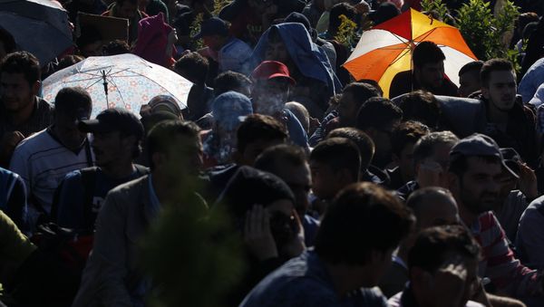 Syrian refugees wait to be escorted to a train after they crossed the Hungarian border from Croatia. - Sputnik International