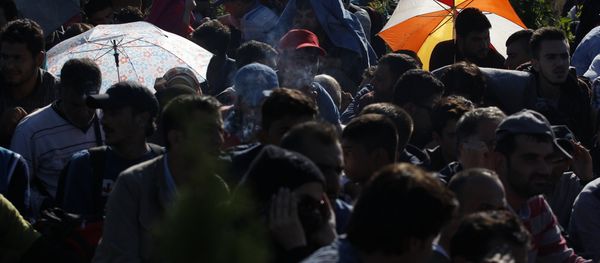 Syrian refugees wait to be escorted to a train after they crossed the Hungarian border from Croatia. - Sputnik International