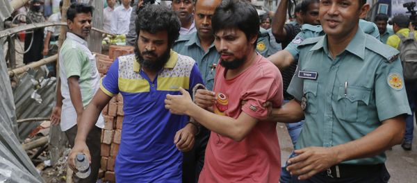 Suspected members of the banned Islamic militant outfit Ansarullah Bangla Team are escorted by policemen along with another suspect from a court in Dhaka, Bangladesh, Wednesday, Aug. 19, 2015. Suspected members of the banned Islamic militant outfit Ansarullah Bangla Team are escorted by policemen along with another suspect from a court in Dhaka, Bangladesh, Wednesday, Aug. 19, 2015. - Sputnik International