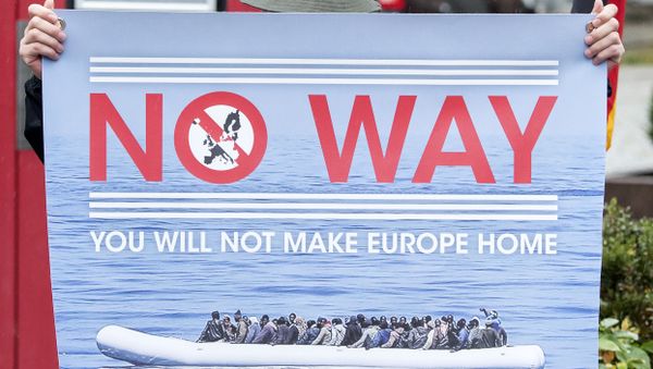 A man holds a banner during a demonstration initiated by right-wing NPD (National Democratic Party of Germany) against the German asylum law and asylum seekers in Riesa, eastern Germany, Tuesday, Aug. 18, 2015. - Sputnik International