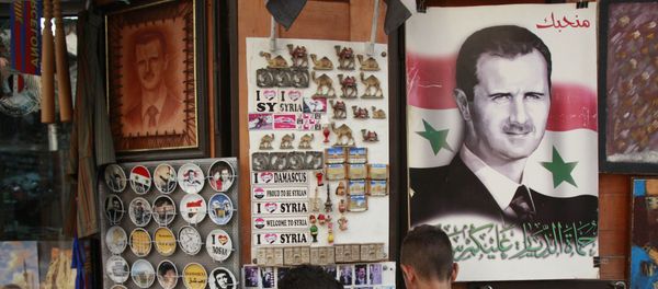 Syrian students, look for souvenir items at a shop displaying a portrait of Syrian President Bashar Assad with Arabic legend reads We love you, in the old city of Damascus, Syria Syrian students, look for souvenir items at a shop displaying a portrait of Syrian President Bashar Assad with Arabic legend reads We love you, in the old city of Damascus, Syria - Sputnik International