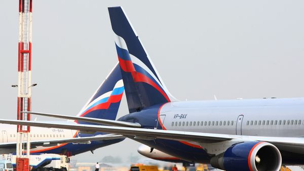 An Aeroflot Boeing 767, right, at the Sheremetyevo International Airport in Moscow - Sputnik International