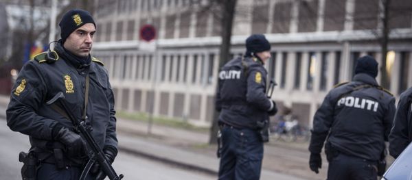 Police officers guard the street around the Noerrebro train station in Copenhagen on February 15, 2015 after a man has been shot in a police action following two fatal attacks in the Danish capital. Police officers guard the street around the Noerrebro train station in Copenhagen on February 15, 2015 after a man has been shot in a police action following two fatal attacks in the Danish capital. - Sputnik International