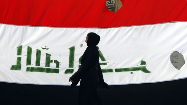 An Iraqi woman walks her national flag during a celebration marking the the departure of US troops from Iraq in Baghdad's Adhamiyah neighbourhood. File photo An Iraqi woman walks her national flag during a celebration marking the the departure of US troops from Iraq in Baghdad's Adhamiyah neighbourhood. File photo - Sputnik International