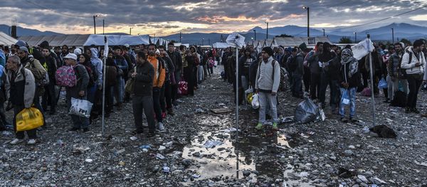 Migrants and refugees wait to board a train near Gevgelija in southern Macedonia after crossing the Greek-Macedonian border on September 27, 2015 - Sputnik International