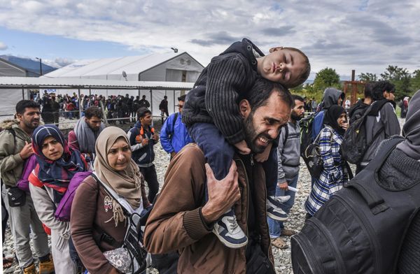 Migrants and refugees stand in line as they wait to board a train at the registration camp after crossing the Macedonian-Greek border near Gevgelija on September 28, 2015 Migrants and refugees stand in line as they wait to board a train at the registration camp after crossing the Macedonian-Greek border near Gevgelija on September 28, 2015 - Sputnik International