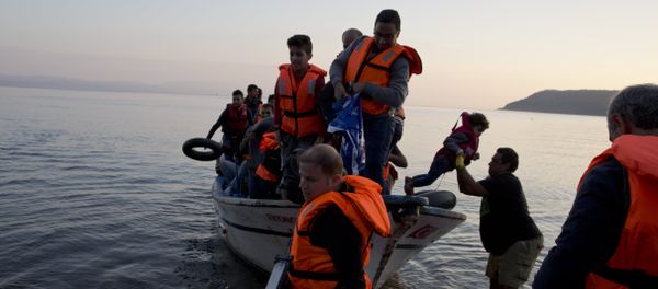 Syrian refugees arrive on a fishing boat from Turkey on the shores of the Greek island of Lesbos , Sunday Sept. 27, 2015 Syrian refugees arrive on a fishing boat from Turkey on the shores of the Greek island of Lesbos , Sunday Sept. 27, 2015 - Sputnik International