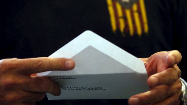Man wearing a T-shirt with an Estelada flag, a symbol of Catalonian pro-independence, prepares his ballot in Catalonia's regional parliamentary election in Barcelona, Spain, September 27, 2015 - Sputnik International