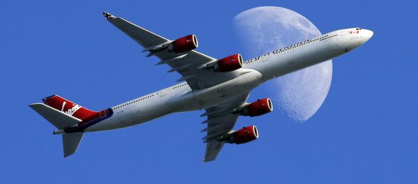 A Virgin Atlantic passenger plane crosses a waxing gibbous moon on its way to the Los Angeles International Airport, Sunday, Aug. 23, 2015, in Whittier, Calif - Sputnik International