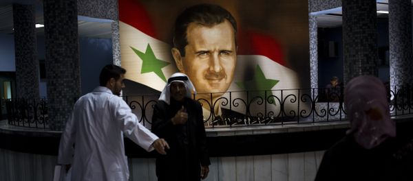 People walk through the Damascus General Hospital past a portrait of the President Bashar Assad in Damascus, Syria, Sunday, May 4, 2014 People walk through the Damascus General Hospital past a portrait of the President Bashar Assad in Damascus, Syria, Sunday, May 4, 2014 - Sputnik International