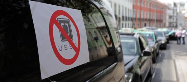 Taxis with signs against the Uber ride-hailing service clog a street in Lisbon while moving at a slow pace in protest, Tuesday, Sept. 8 2015 Taxis with signs against the Uber ride-hailing service clog a street in Lisbon while moving at a slow pace in protest, Tuesday, Sept. 8 2015 - Sputnik International
