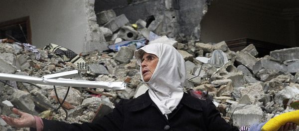 Syrian woman stands amid the ruins of her house . Syria (File) - Sputnik International