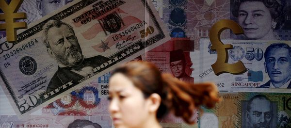 A woman walks past a money exchange shop in Kuala Lumpur, Malaysia, in this August 25, 2015 file photo - Sputnik International